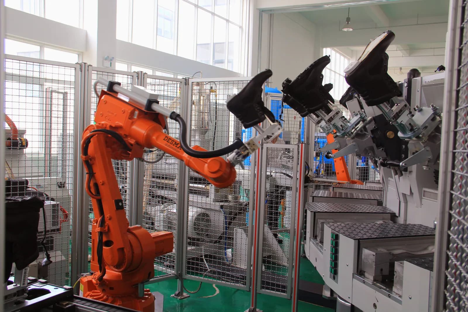 Automated footwear manufacturing equipment in safety shoe production workshop